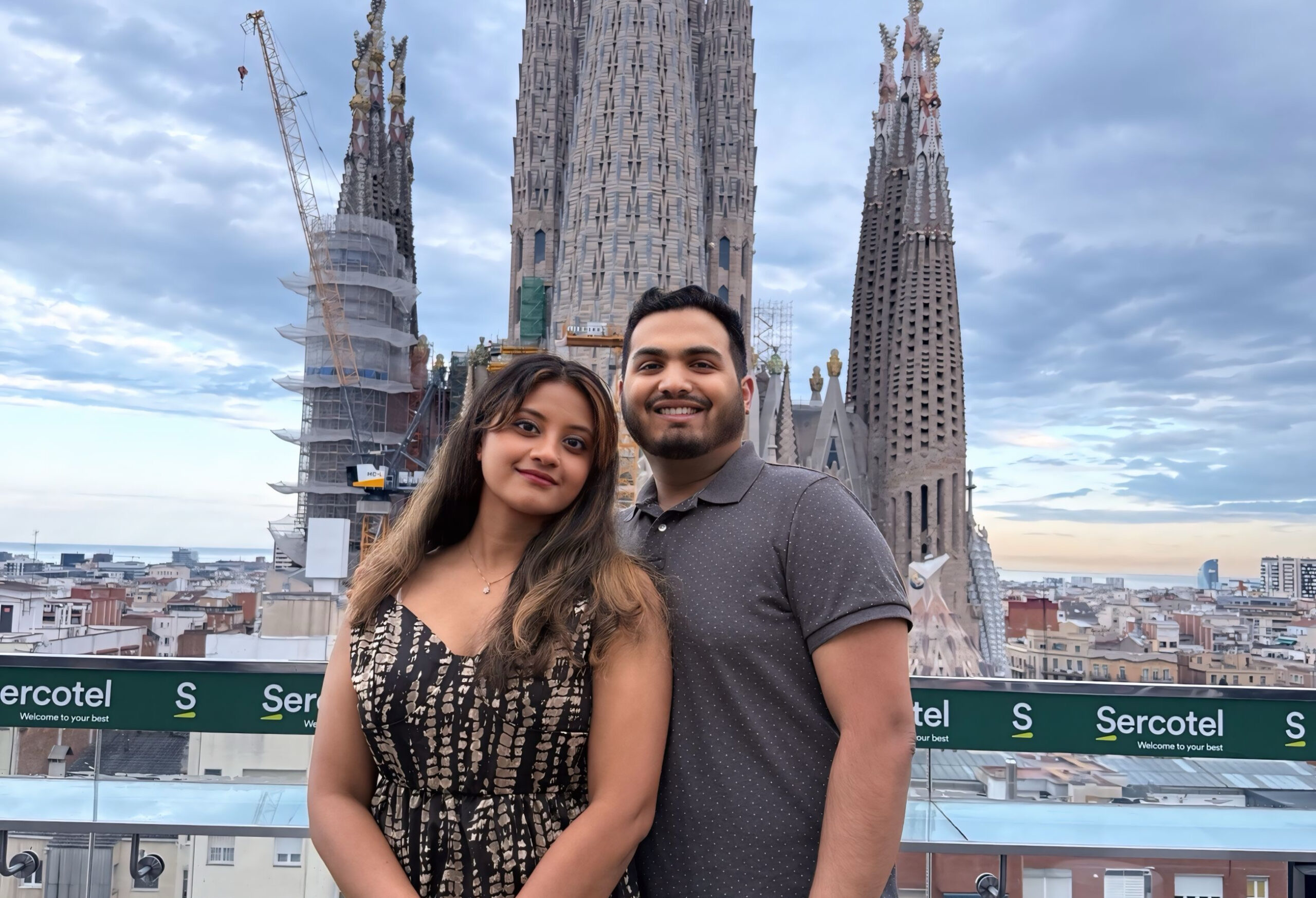 Nivina and Jithin at a Rooftop bar with the view of the Sagrada Familia in Barcelona